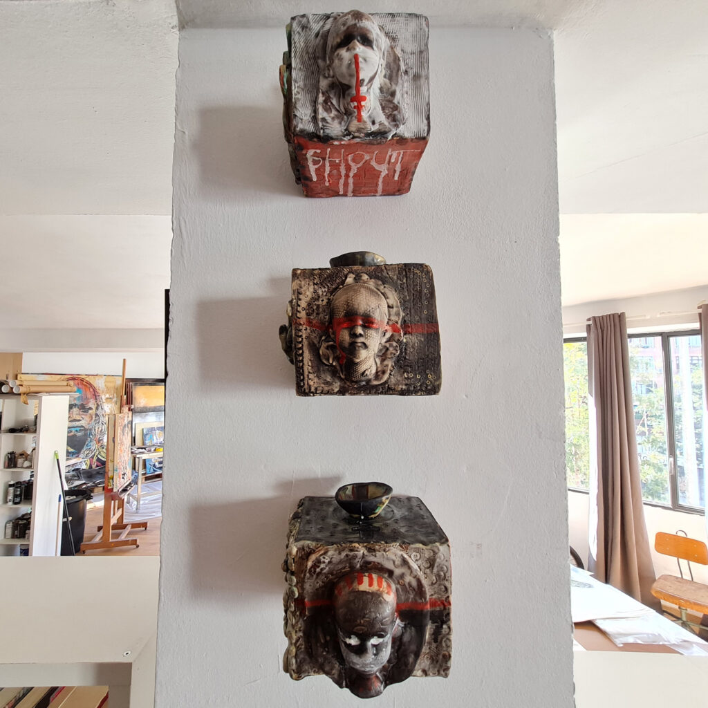 a sculpture of a person's face on a wall