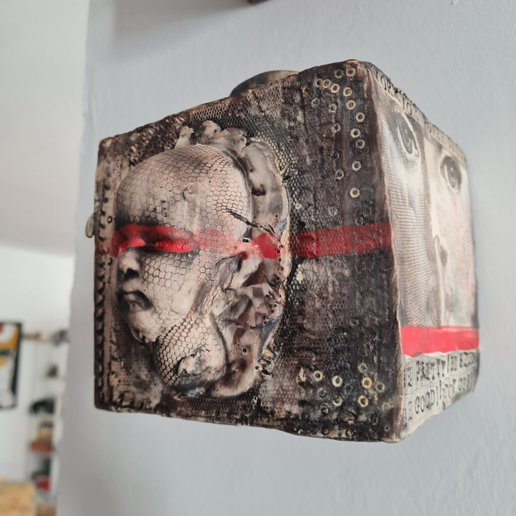 a sculpture of a person's face on a wall