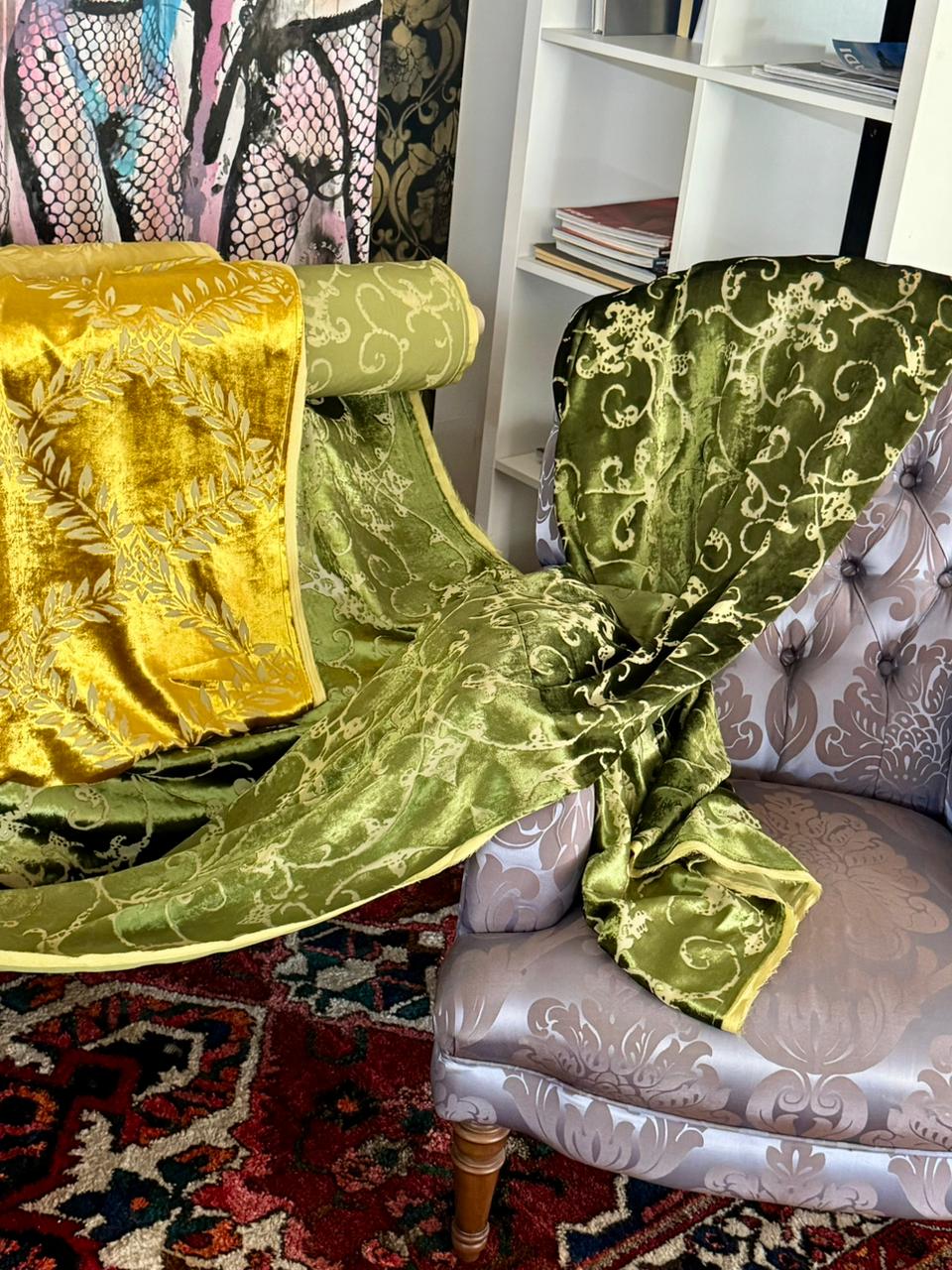 Green Italian velvet draped over an upholstered armchair inside Factory BCN showroom.