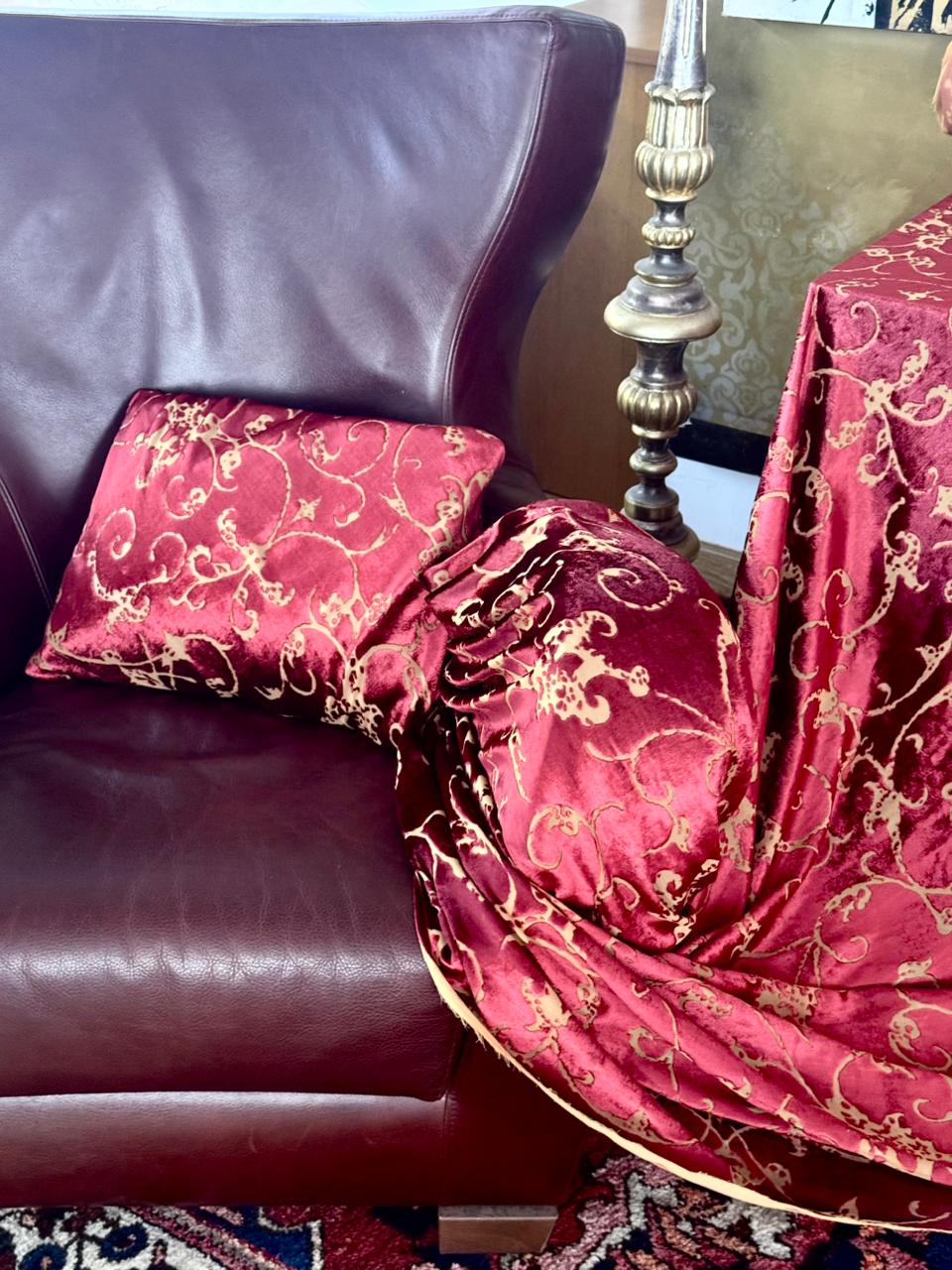 Italian velvet fabric styled on a leather armchair with coordinated cushions inside Factory BCN.