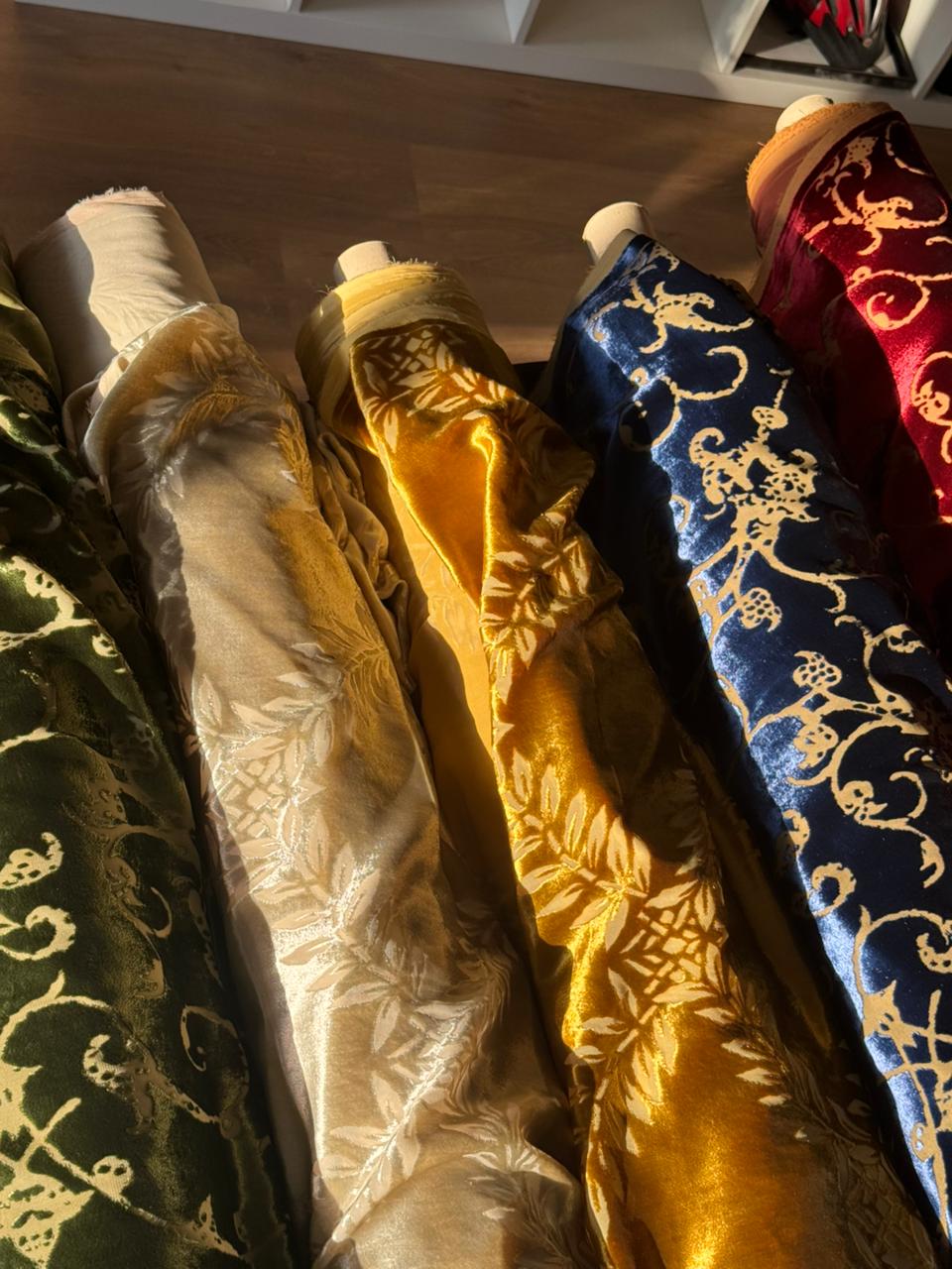 Multiple rolls of Italian velvet fabrics arranged for consultation at Factory BCN.