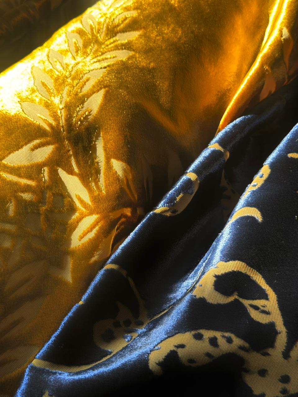 Close-up of gold and blue Italian velvet fabric with detailed floral pattern.