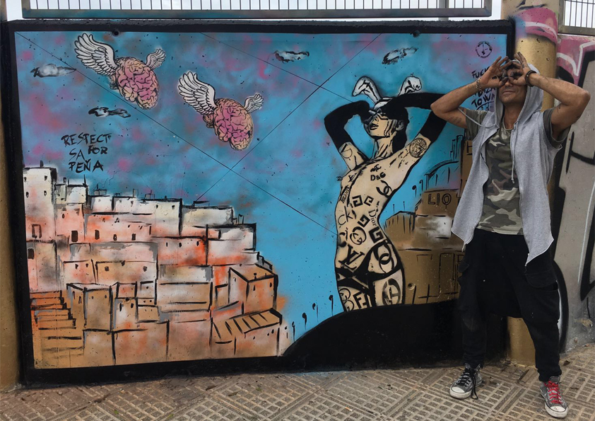 Completed colorful street art mural by White Rabbit featuring a female figure and flying brain motifs in Ibiza